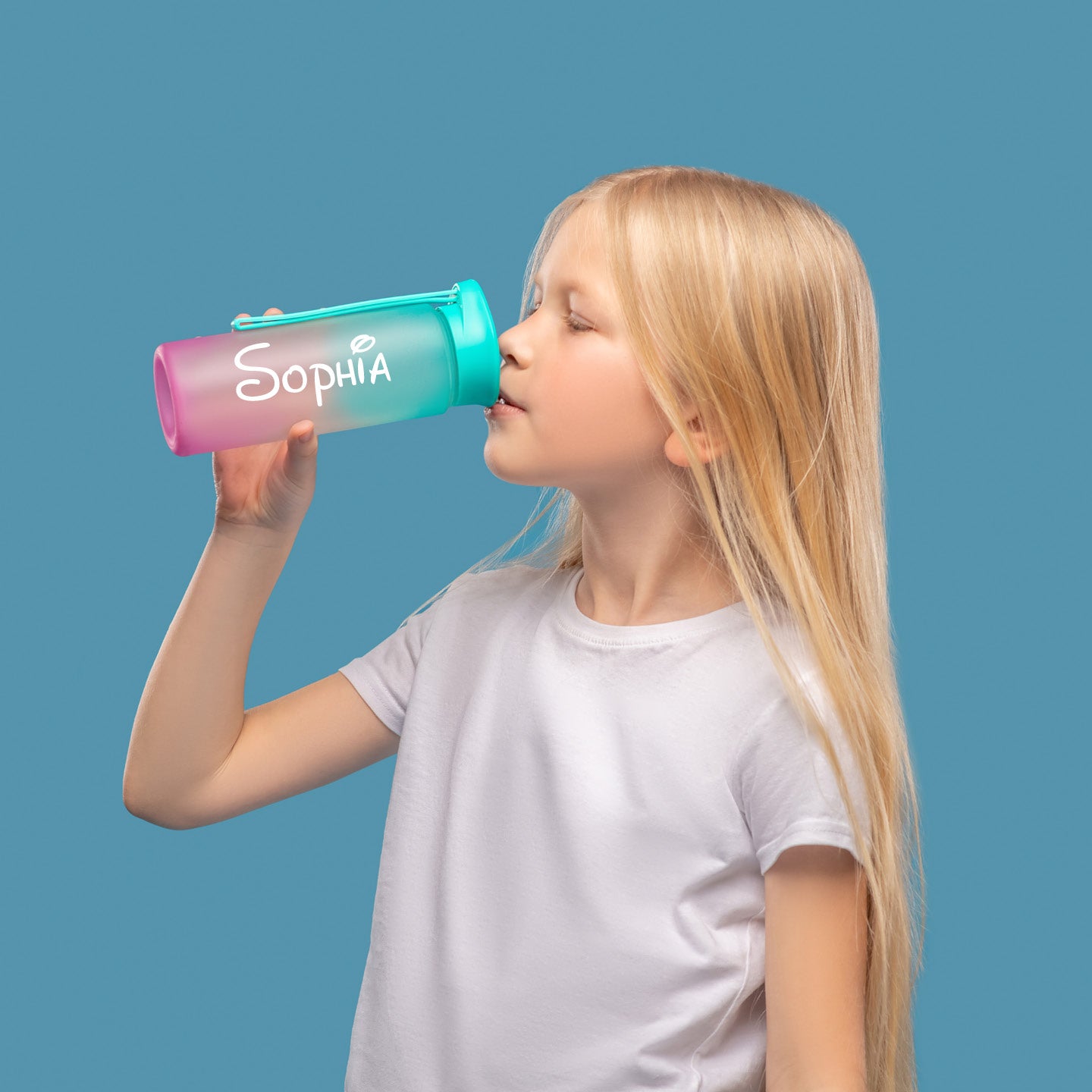 Young girl drinking from a colorful water bottle with 'Sophia' vinyl decal on a blue background