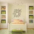 A children's bedroom featuring a black line art Pikachu wall decal centered on a light sage green wall above a white wooden bed. The room is styled with built-in shelves on both sides containing green checkered storage bins, a white chandelier, and a light green rug.